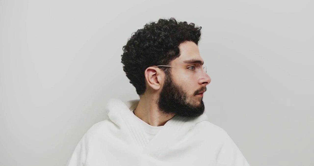 A man turning his head to profile in a video, before and after a face swap